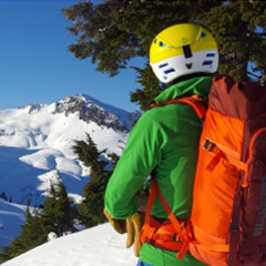 woman in ski helmet looking at snowy terrain