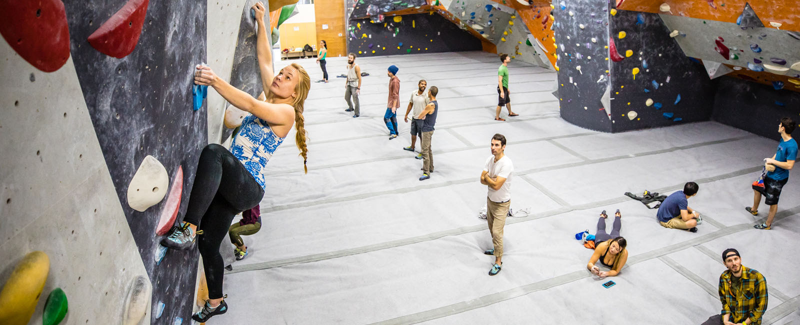 blonde girl with braid bouldering